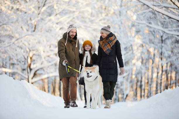 istock Family Enjoying Walk with Dog 1130366645