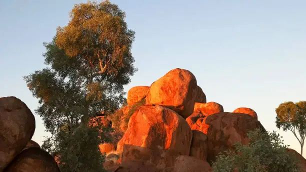 a close up of the devil's marbles in australia's northern territory at sunset