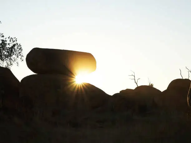 the devil's marbles and sunbeams at sunrise in the northern territory