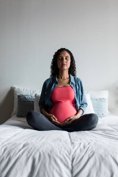 istock Pregnant woman meditating on the bed 1130368941