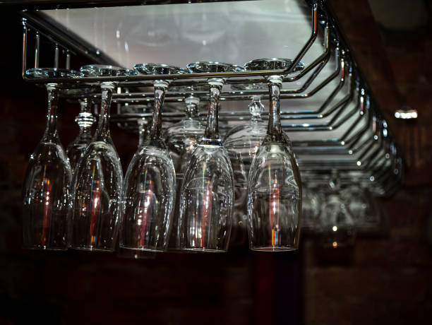 istock Clean washed and polished glasses hanging over a bar rack 1130370279
