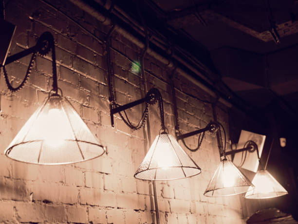 istock Vintage lighting lamp hang in front of cement brick wall at loft 1130370342