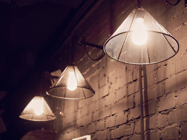istock Vintage lighting lamp hang in front of cement brick wall at loft 1130370344