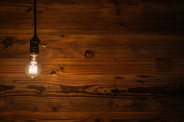 Photo of light bulb against a wooden background (HDRi)