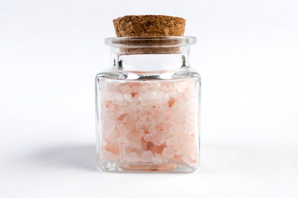 istock Himalayan pink salt  in a glass jar isolated on white background 1130372749