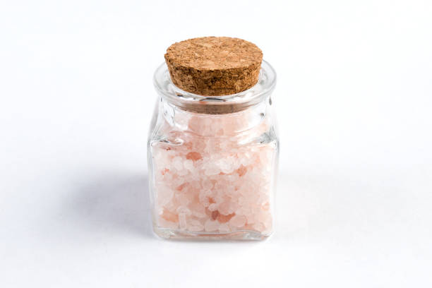 istock Himalayan pink salt  in a glass jar isolated on white background 1130372781