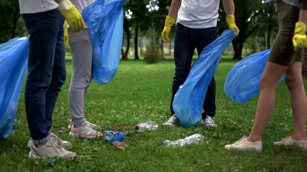 society against pollution, active citizens collecting garbage in public park - wasting time imagens e fotografias de stock