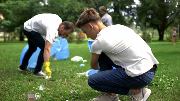 istock People picking up rubbish in plastic bag, waste treatment problem, recycling 1130373964