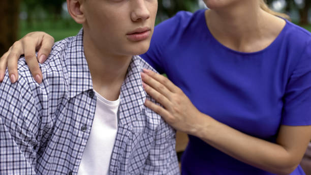 istock Mother supporting her upset son, listening his problems in school, bullying 1130374101