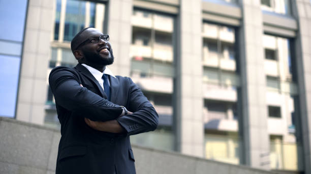 istock Successful architect crossed arms looking up at finished building, professional 1130374295