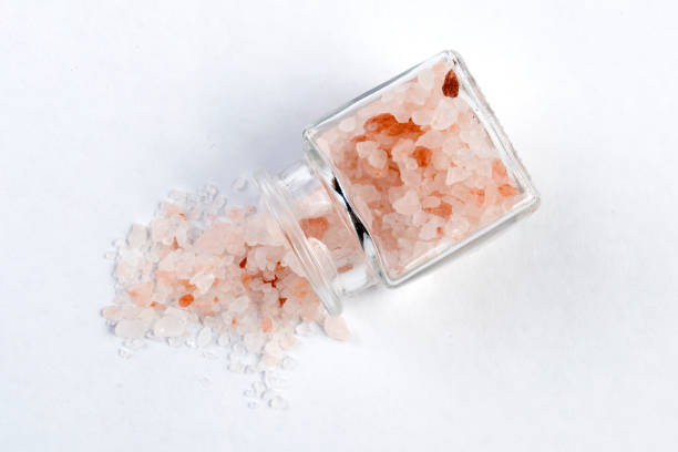 istock Himalayan pink salt  in a glass jar isolated on white background 1130374379