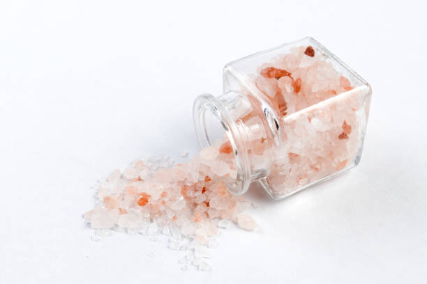 istock Himalayan pink salt  in a glass jar isolated on white background 1130374387