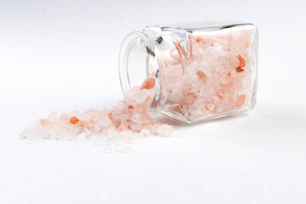 istock Himalayan pink salt  in a glass jar isolated on white background 1130374390