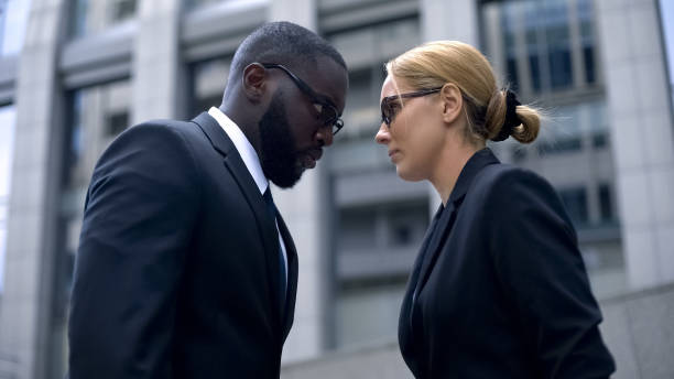 istock Competition at work, female and male co-workers leaning foreheads, concept 1130375193
