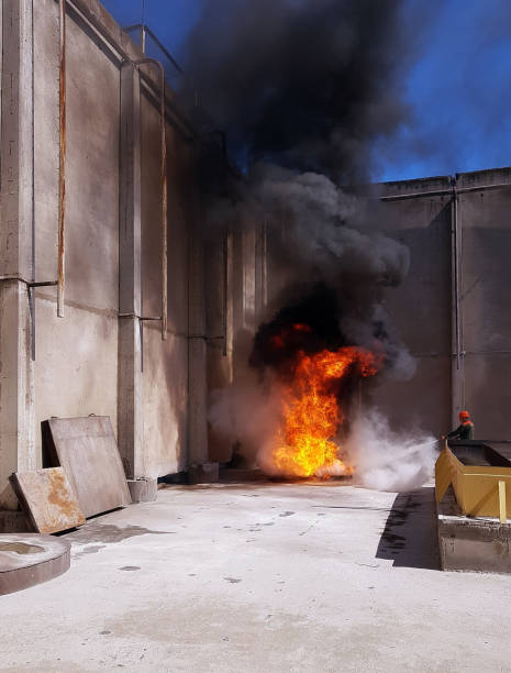 istock fireman extinguishes the fire with smoke. Firefighting exercises with fire extinguishing. 1130375438