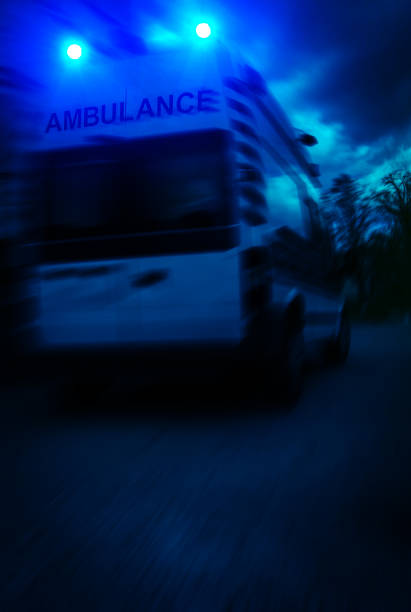 Elderly man in ambulance getting treated by paramedics