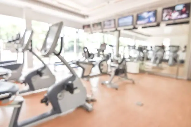 Photo of Blur gym background fitness center or health club with blurry sports exercise equipment for aerobic workout and bodybuilding
