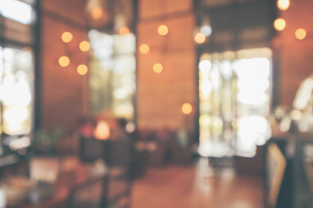 istock Restaurant cafe or coffee shop interior with customer blur abstract vintage style bokeh light for montage product display background 1130377067