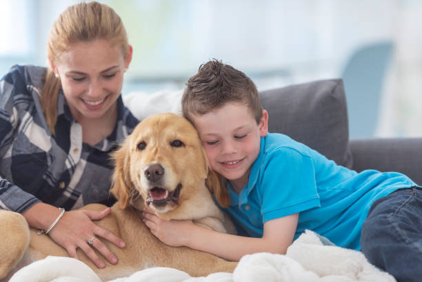 istock Brother and sister hug their dog 1130377400