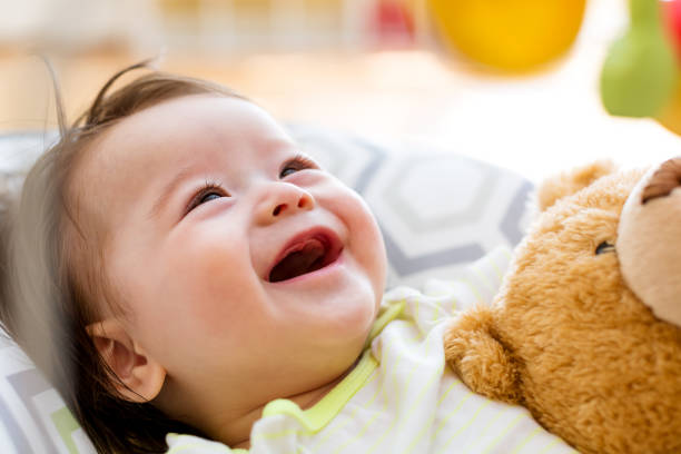 Little Child Girl Hugging Her Toy Bear At Home Nearby Window