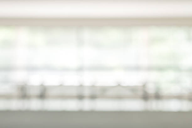istock Business office corridor blur background interior view empty lobby hallway with glass wall white room and light bokeh 1130379627