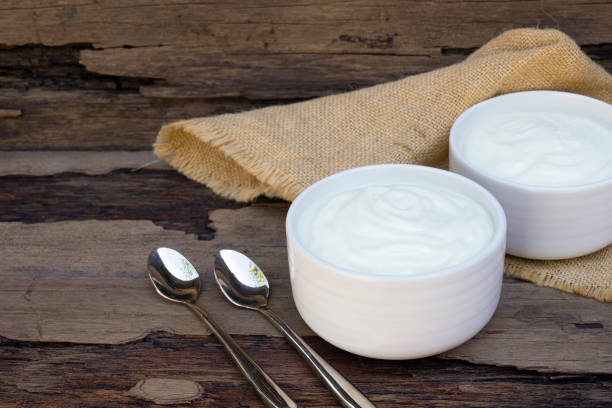 istock Yogurt  In white glass wood background. 1130381555