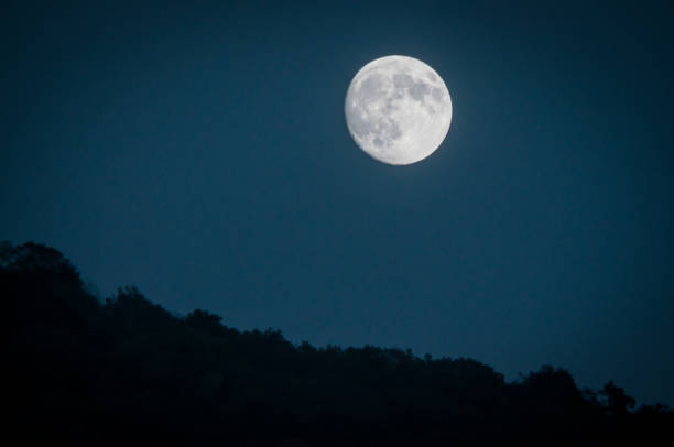 istock Dramatic mountain moon rise with deep blue night time sky and layered hills in the distance. 1130384332