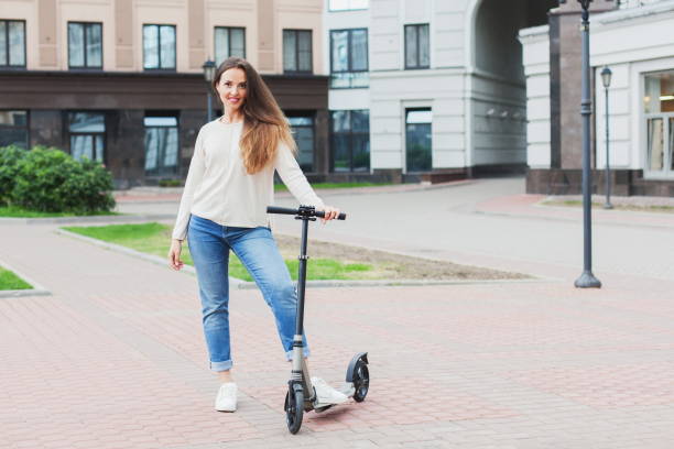 istock A young beautiful girl riding a scooter. 1130388262
