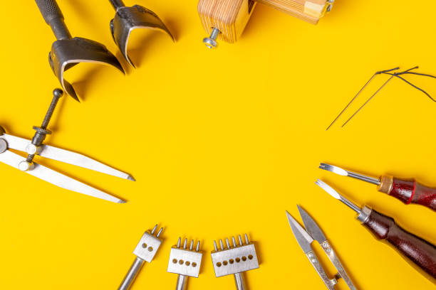istock Leather craft tools on a yellow background with empty space for text. Handmade and hobby theme 1130390889