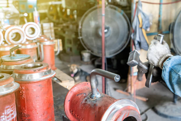 istock worker or operator cleaning welding seam slag remove by knock with hammer and chisel at factory 1130391052