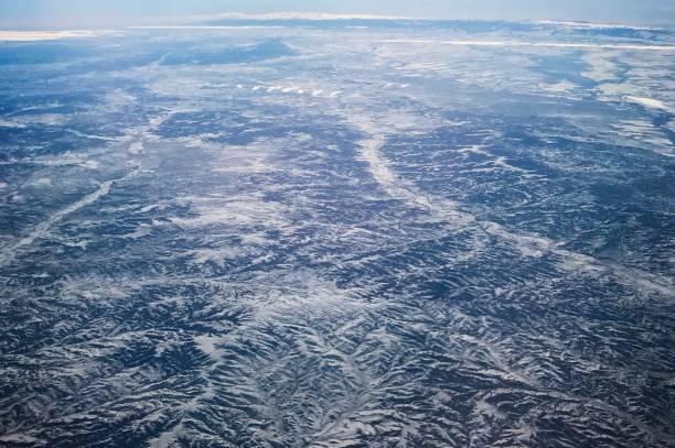 view of mountains from airplane flying above - mountain range earth sky airplane imagens e fotografias de stock