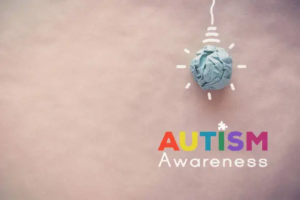 Photo of Blue paper light bulb , world Autism awareness day