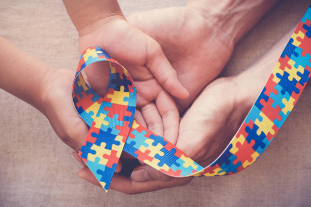 istock Hands holding puzzle ribbon for autism awareness 1130393911