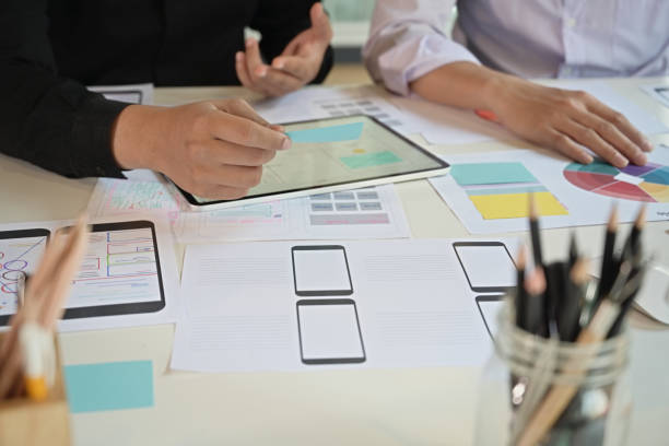 istock UI UX designer meeting at office and designing wireframe layout for responsive mobile 1130395132