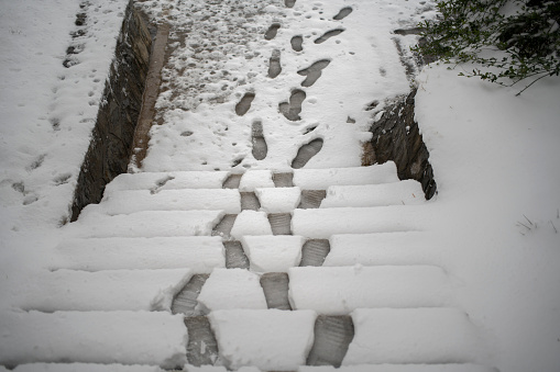 footprint on snow-covered steps