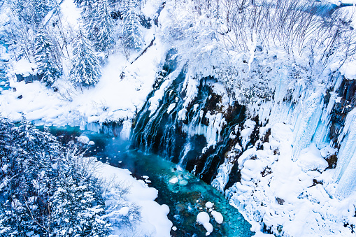 Beautiful outdoor nature landscape with shirahige waterfall and bridge in snow winter season Hokkaido Japan