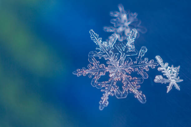 istock Single snow flake on blue and green background 1130404498