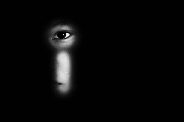 eye of boy through key whole, child abuse concept eye of boy through key whole, child abuse concept kidnapping photos stock pictures, royalty-free photos & images