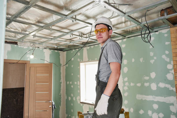 istock Room repair. Interior finish. young builder makes a plasterboard ceiling, standing on a stepladder 1130406780
