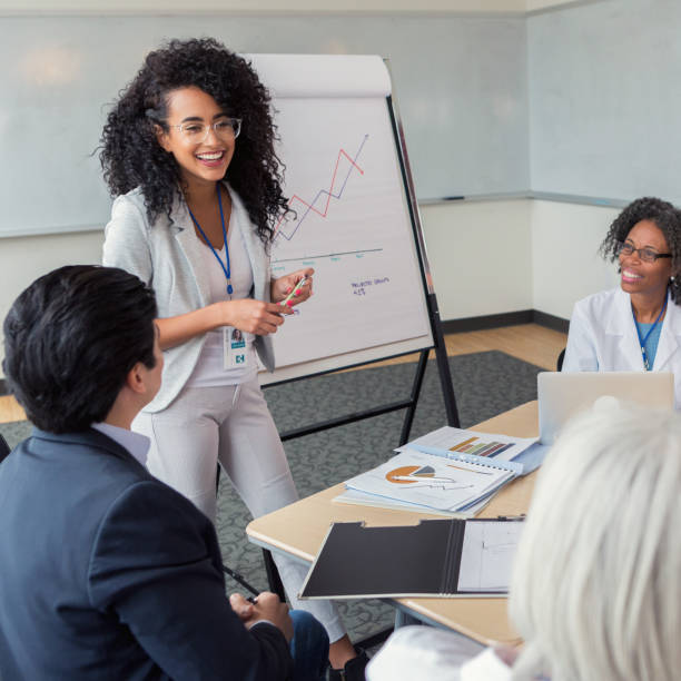 istock Cheerful female hospital administrator gives presentation 1130406787