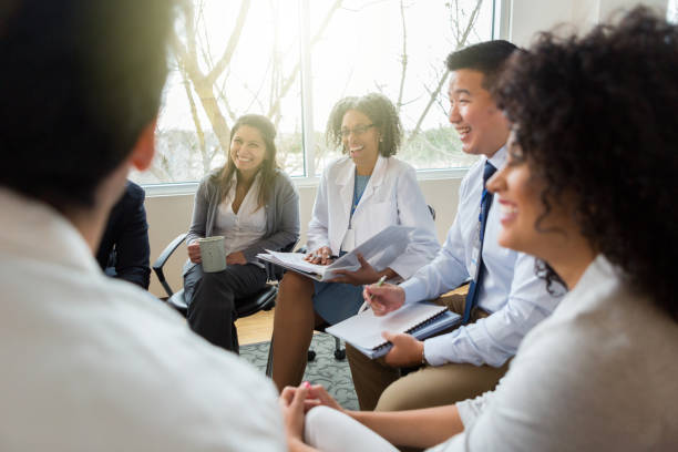 Hospital management meets with healthcare professionals Confident diverse group of hospital administrators sit down to discuss important issues withe healthcare professionals. medical occupation stock pictures, royalty-free photos & images