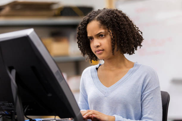 istock Confused teenage girl using computer 1130406899