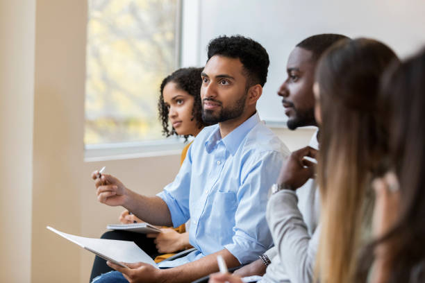 istock Businessman asks question during business seminar 1130407605