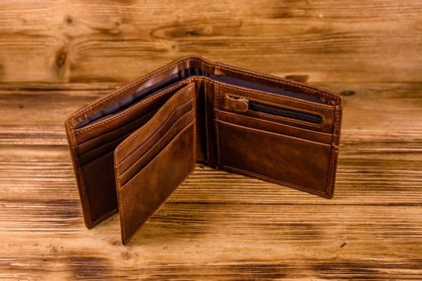 istock Opened brown leather wallet on wooden table 1130407877