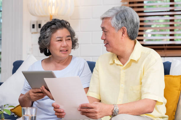 istock Asian senior couple use tablet searching about retirement financial document sitting on sofa at home,senior learn to use technology.aging in place concept. 1130407959