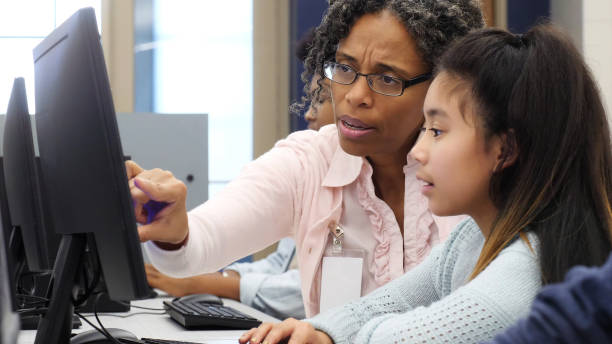istock Mature woman mentors elementary student 1130408115