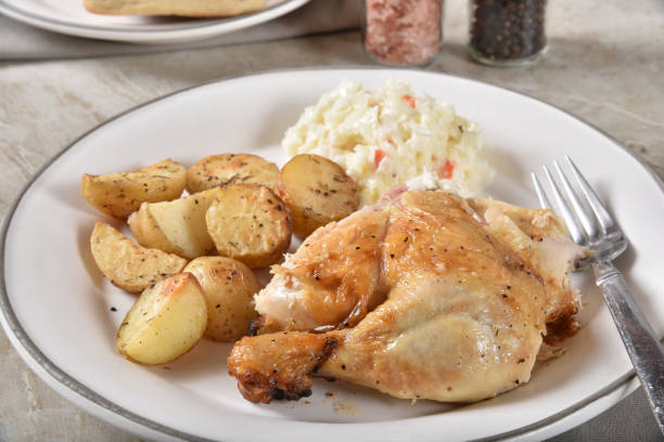 Chicken dinner A healthy chicken dinner with roasted baby potatoes and coleslaw drumstick stock pictures, royalty-free photos & images