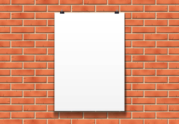 istock Blank poster mockup on the paper clips in front of brick wall 1130413404