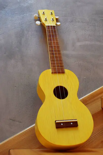 Photo of Yellow traditional soprano ukulele guitar