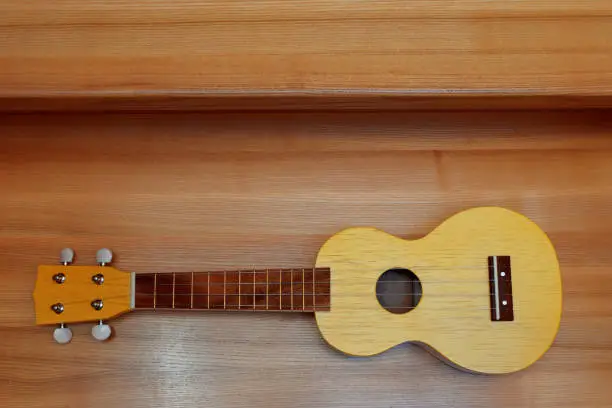 Photo of Yellow traditional soprano ukulele guitar